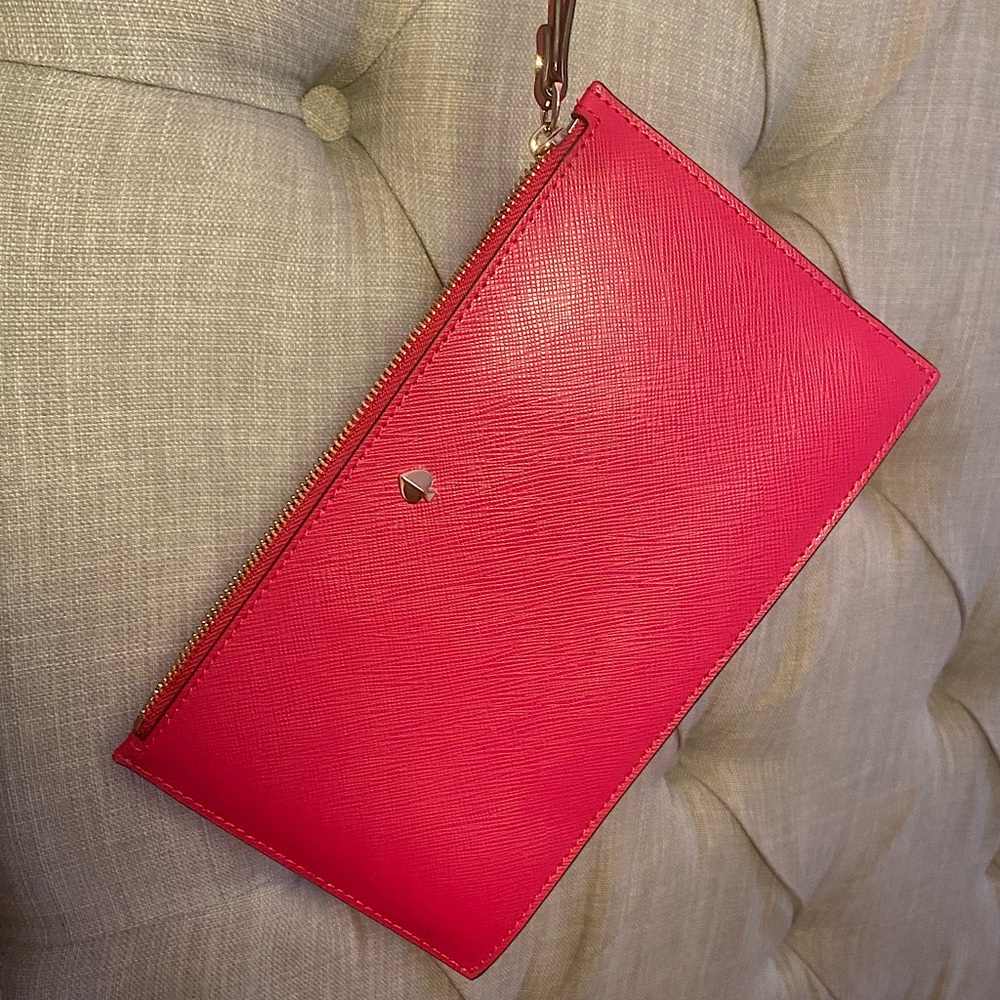 Pink Kate Spade Roulette Wristlet with gold hardware